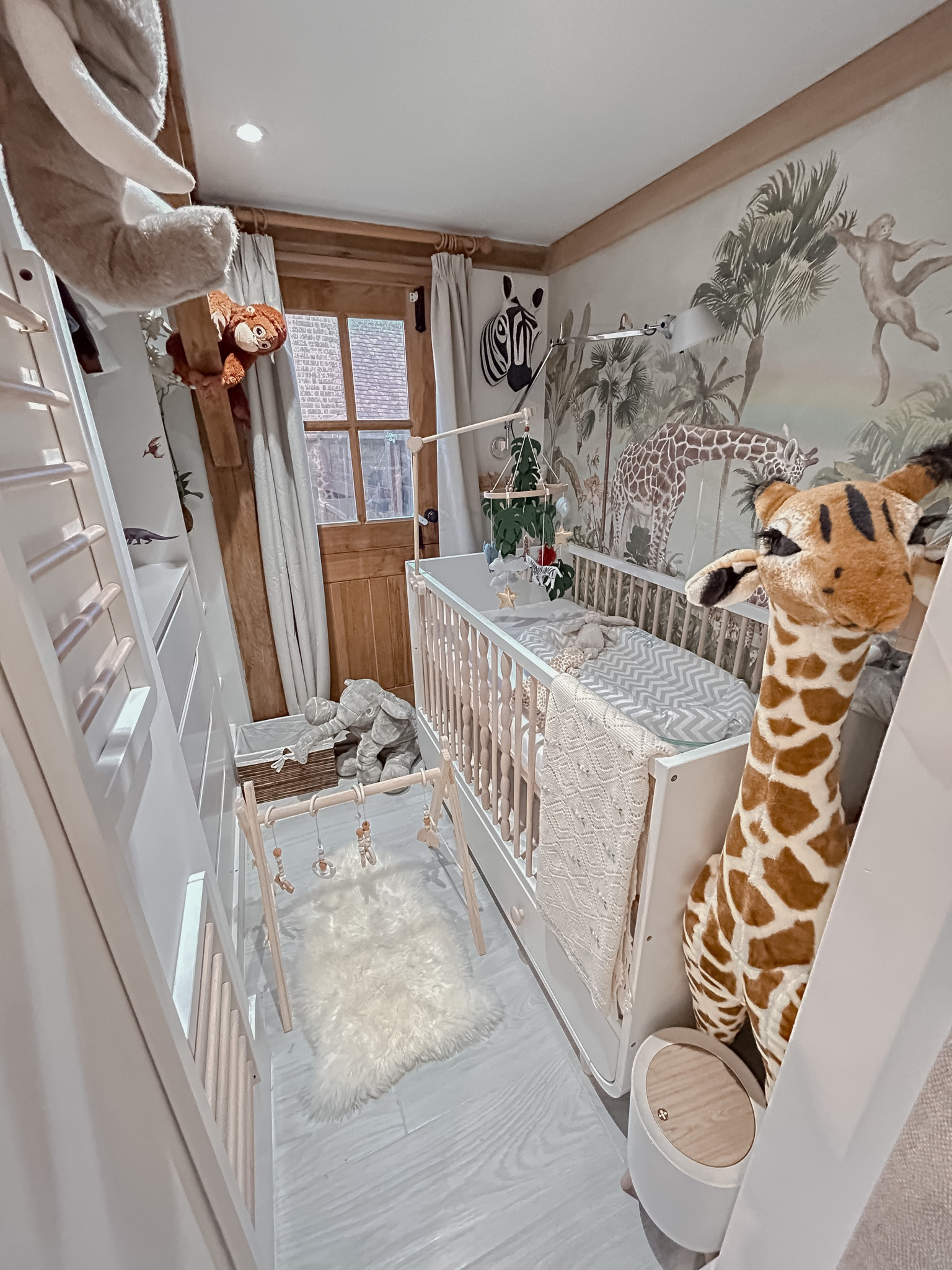 Baby nursery  🤍 
Animal kingdom🍃🦒

Baby nursery,  baby cot bed, nursery wall paper , sheep skin, baby play gym, stuff elephant, stuff monkey, baby mobile , nursery mobile, cot bed sheets, blackout curtains, rattan basket, safari mobile, curtain pool , wooden curtain pool, nursery decor 

#LTKkids #LTKbaby #LTKhome