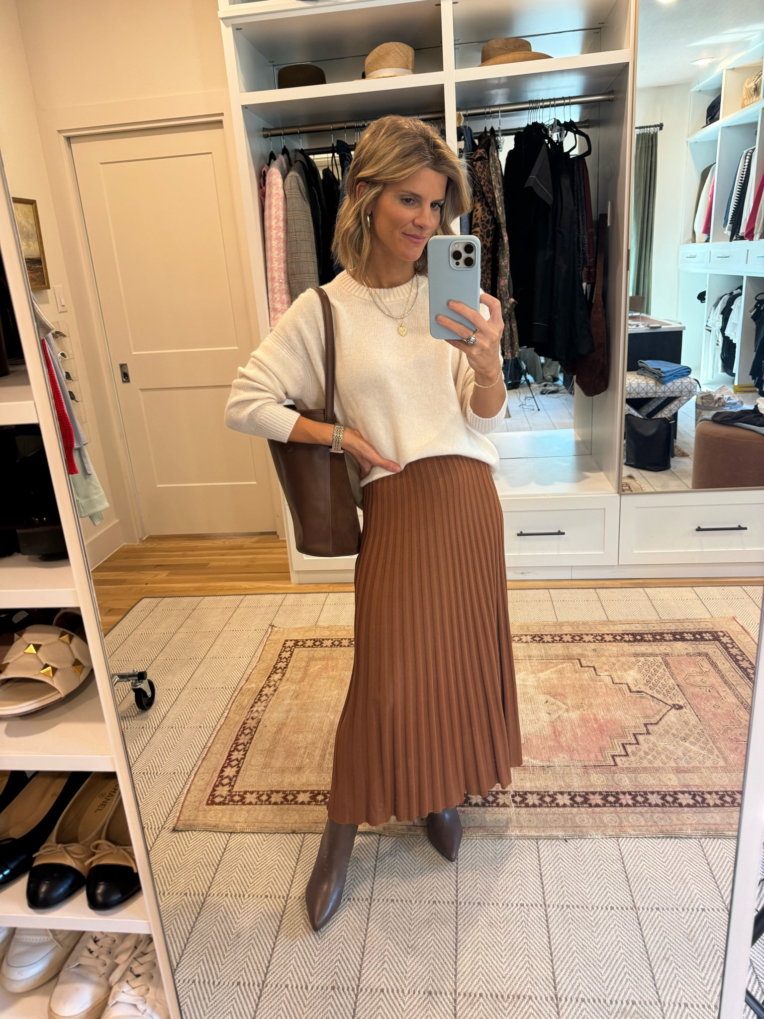 Wearing XS in sweater and skirt