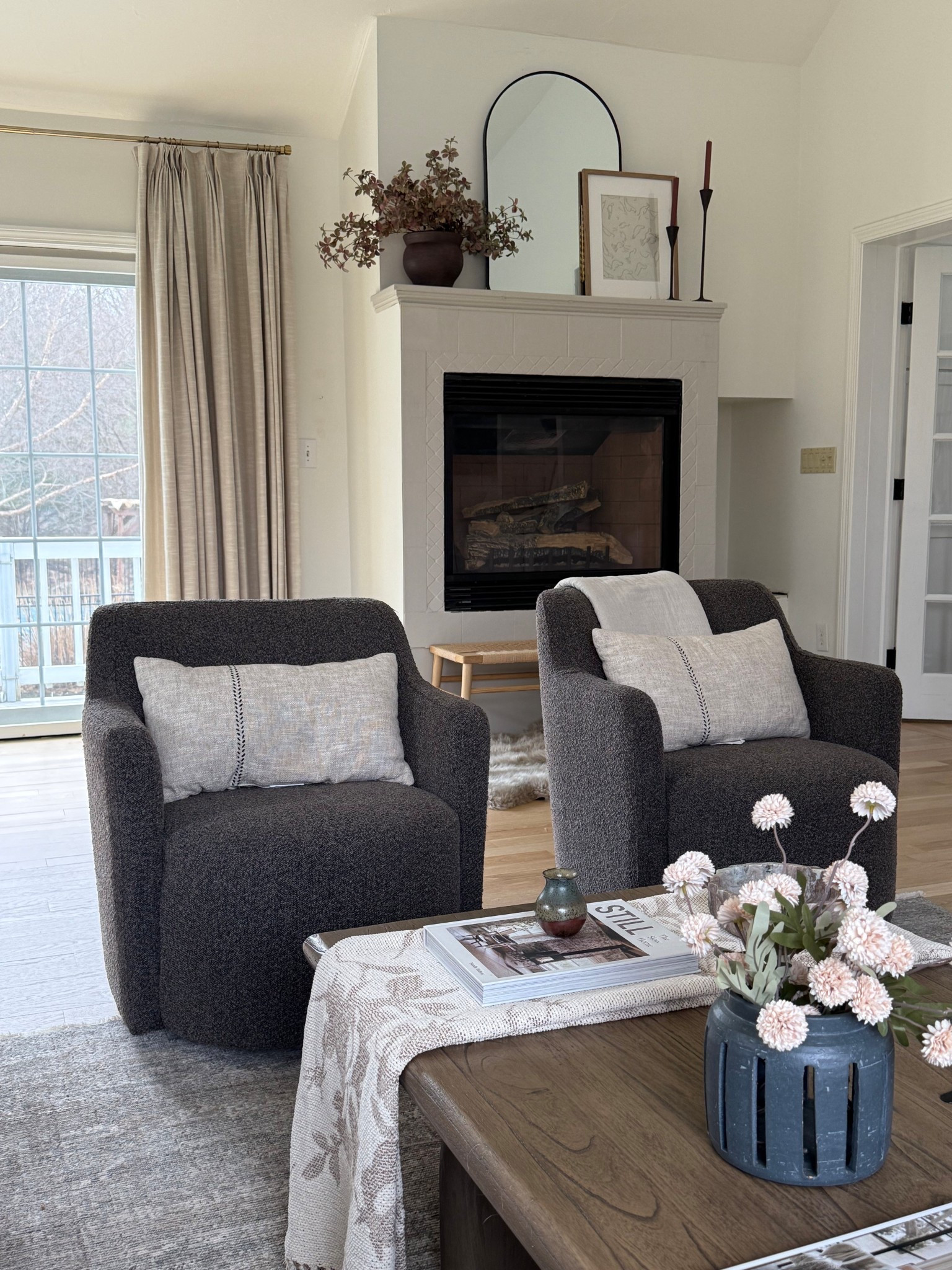 Living room views these brown boucle chairs are still a favorite and they swivel! We have cats and they have holding up great! Using this throw to break up the wood coffee table is one my my favorites in this room!

#LTKHome