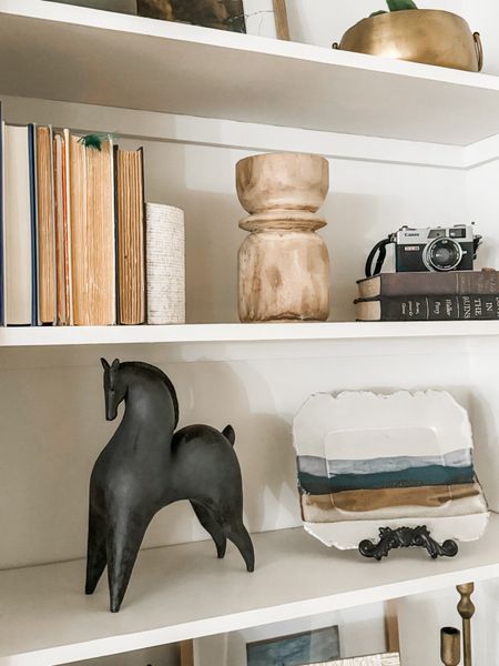 Shelf styling is fun when you use interesting pieces that spark conversation. Like this horse sculpture and vintage camera. 

#LTKstyletip #LTKhome #LTKfindsunder50