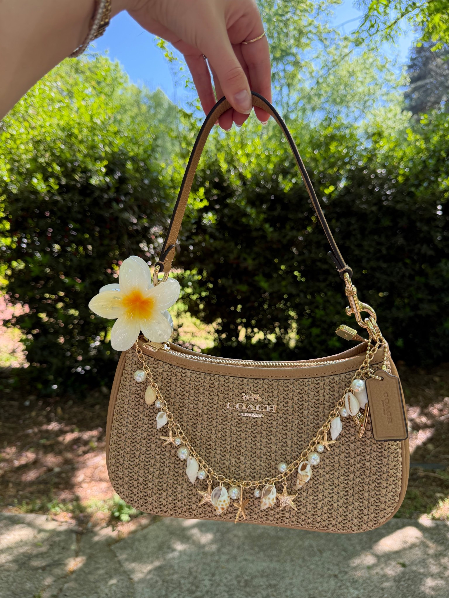 Bag of the day 🐚☀️
Raffia Coach Teri with tropical flower claw clip
Seashell and gold starfish bag chain
Bag charm
Coach outlet 

#LTKSeasonal #LTKootd