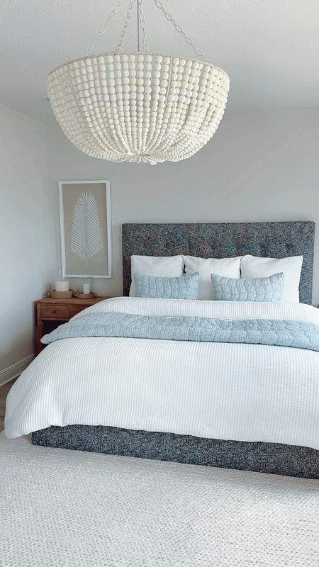 Bedroom Inspo ☁️✨ Add these to make your home feel bright, airy, + cozy with a touch of modern coastal vibes! 

Begin with a classic white foundation by using the best-selling white honeycomb duvet cover and matching pillow shams. These have a subtle texture so it's not "blah."

My trick to making the bed look extra cozy, comfy, and cloud-like is by adding an extra comforter inside (or under) the duvet cover.

Then, use the chambray cloud quilt and matching shams to add a pop of color that gives the room the calming coastal color palette. 

Using these linens with different textures also adds dimension to the space!

Another way to add interest to the space is with decor! The white-washed wood bead chandelier adds character and charm while also functionally providing more light to brighten the room.

The Sausalito nightstands are shown in a seafrift finish which gives the bedroom a beachy, coastal look. They are very solia and provide wide drawers for storage. This collection from Pottery Barn has a variety of size options and matching furniture (like dressers, storage...)

The ivory chunky knit sweater handwoven rug makes the room feel cozy all year long! It comes in a variety of sizes. We used the 9'x12' to go with our king bed.

The artisan handcrafted ceramic hurricane candleholders in white gray compliment the nightstands!
The palm leaf wall art helps to balance the room and adds to the coastal feel.

Modern Coastal Bedroom, Master Bedroom, Home Decor, Modern Coastal Home, Coastal Bedroom, Neutral Home Decor, Bedding, Pottery Barn, Bedroom Inspiration, Neutral Bedroom, Florida Home, Beach House, Home Inspo, Neutral Home, Neutral Bedroom, guest bedroom, beach home, bedroom styling, bedroom wall art, bedroom chandelier, beaded chandelier, wood bead chandelier, master bedroom styling, master bedroom decor, beach home decor, Sausalito nightstand, natural wood nightstand, bedroom set, bedroom furniture, master bedroom bedding, neutral bedding, coastal bedding, white bedding, blue bedding, nightstand styling, console table styling, cozy bedroom

#LTKStyleTip #LTKHome #LTKSaleAlert