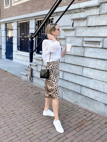 Favorite casual transitional outfit for fall - a sweater over a satin midi skirt. This animal print midi skirt is Realisation Par - I’ve linked a few resale and similar ones below. I wear an XXS but it runs true to size. Also linked my favorite Krewe sunglasses that I wear constantly!

White sneakers & crossbody bag are YSL, but also linked out other options. All links are global xx

Fall look, fall outfit, #fallootd #transitionalstyle #fallstyle #whitesneakers #yslbag 

#LTKstyletip #LTKeurope #LTKSeasonal