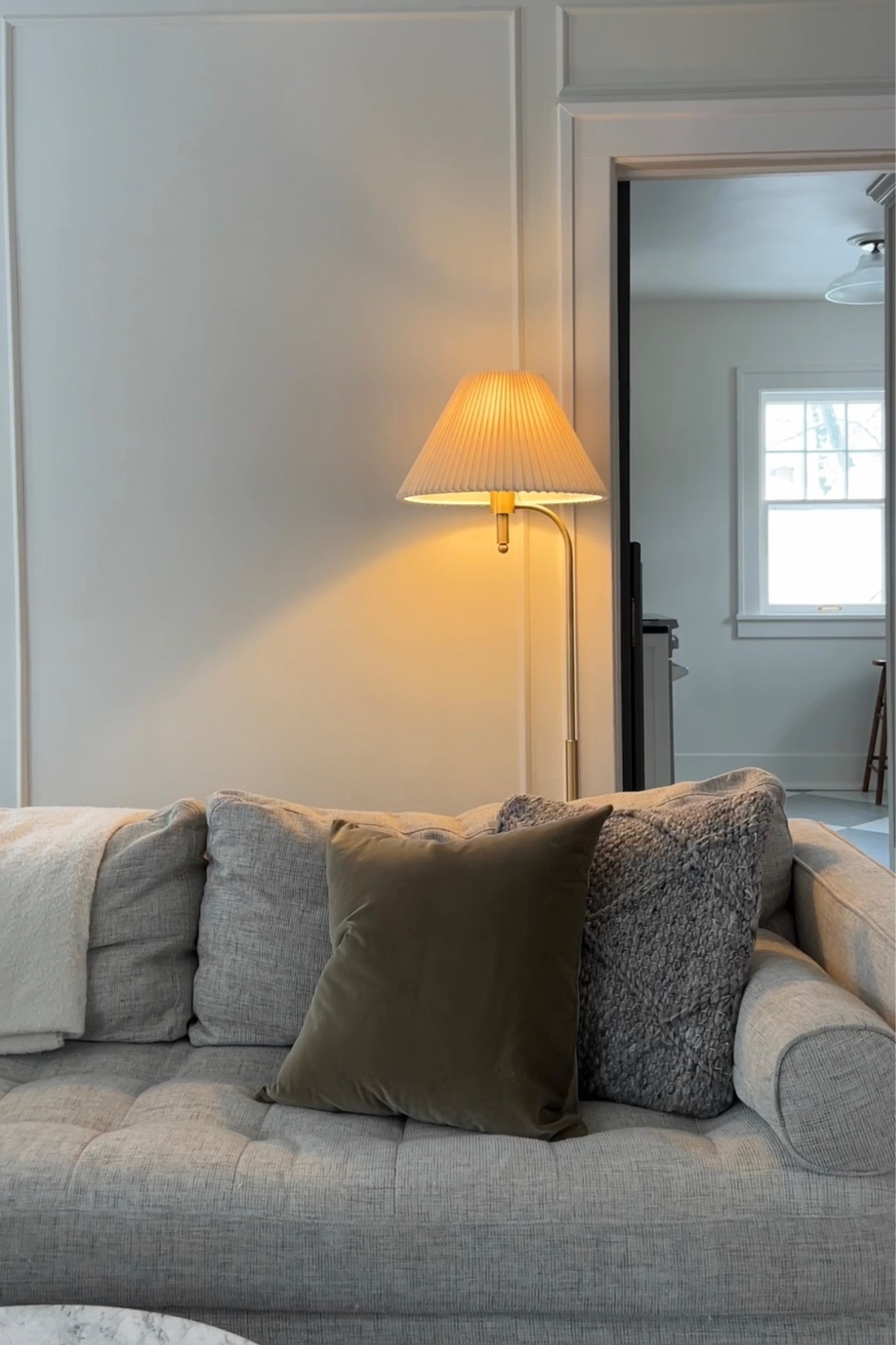 Cozy living room with pleated lamp shade and velvet pillow cover 

#LTKhome