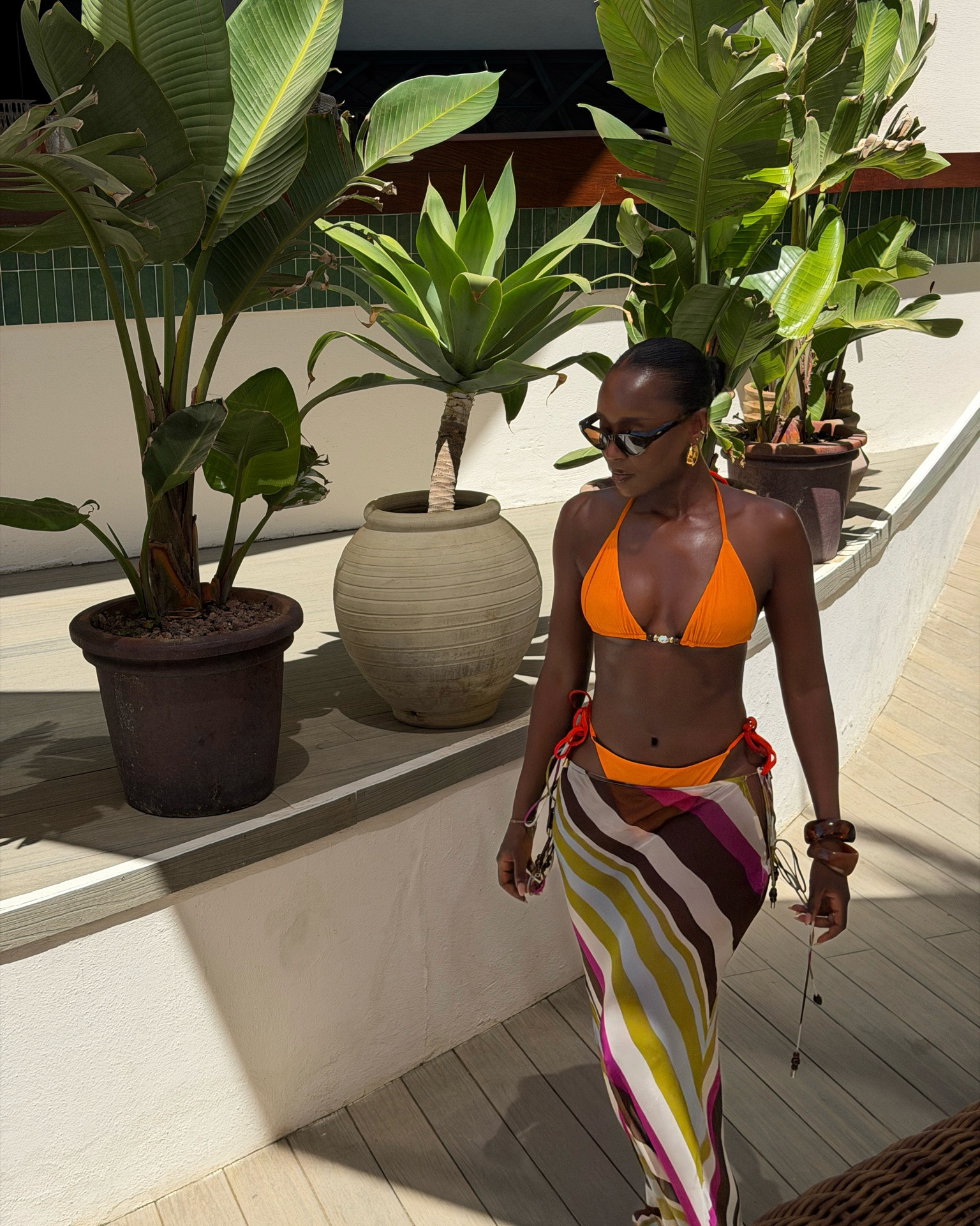 Nikki beach club outfit, orange reversable bikini with stripe sheer skirt— For 20% off use ´KMCOCO20’ valid for a week

#LTKsummer #LTKswimwear #LTKstyletip