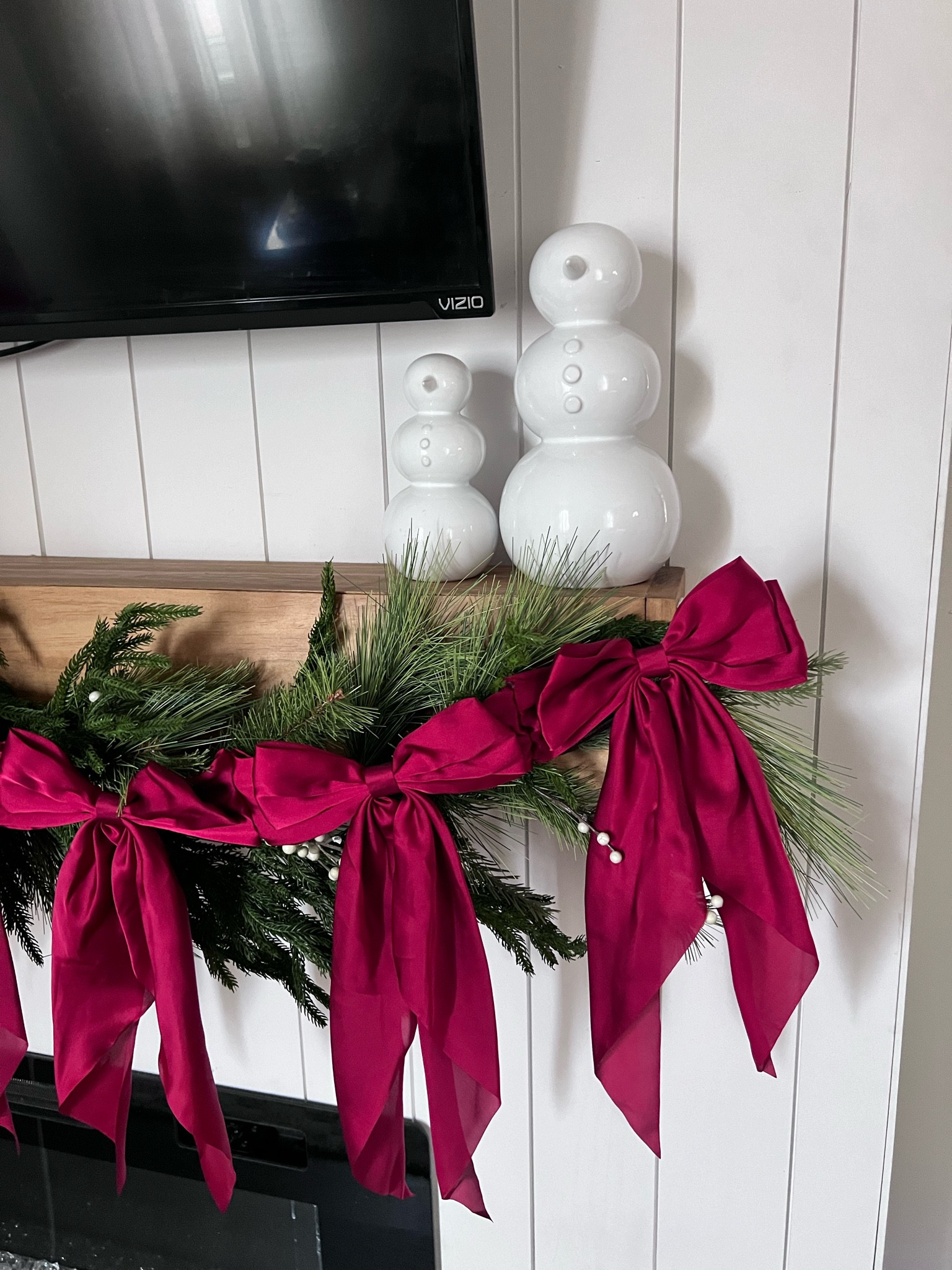 Fireplace mantle with holiday home decor with crate and barrel snowmen and pine garland with bows

#LTKHoliday #LTKCyberWeek #LTKSeasonal