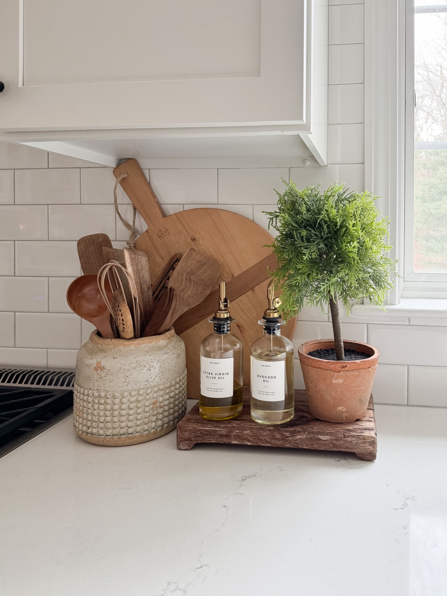 Simple countertop styling with wood accents and glass bottles creates an elevated everyday kitchen moment. coastal kitchen decor, kitchen styling ideas, oil and vinegar bottles, neutral home decor, designer inspired kitchen, coastal interiors, natural textures, kitchen inspiration, sherricalnanhome

#LTKHome #LTKFindsUnder50