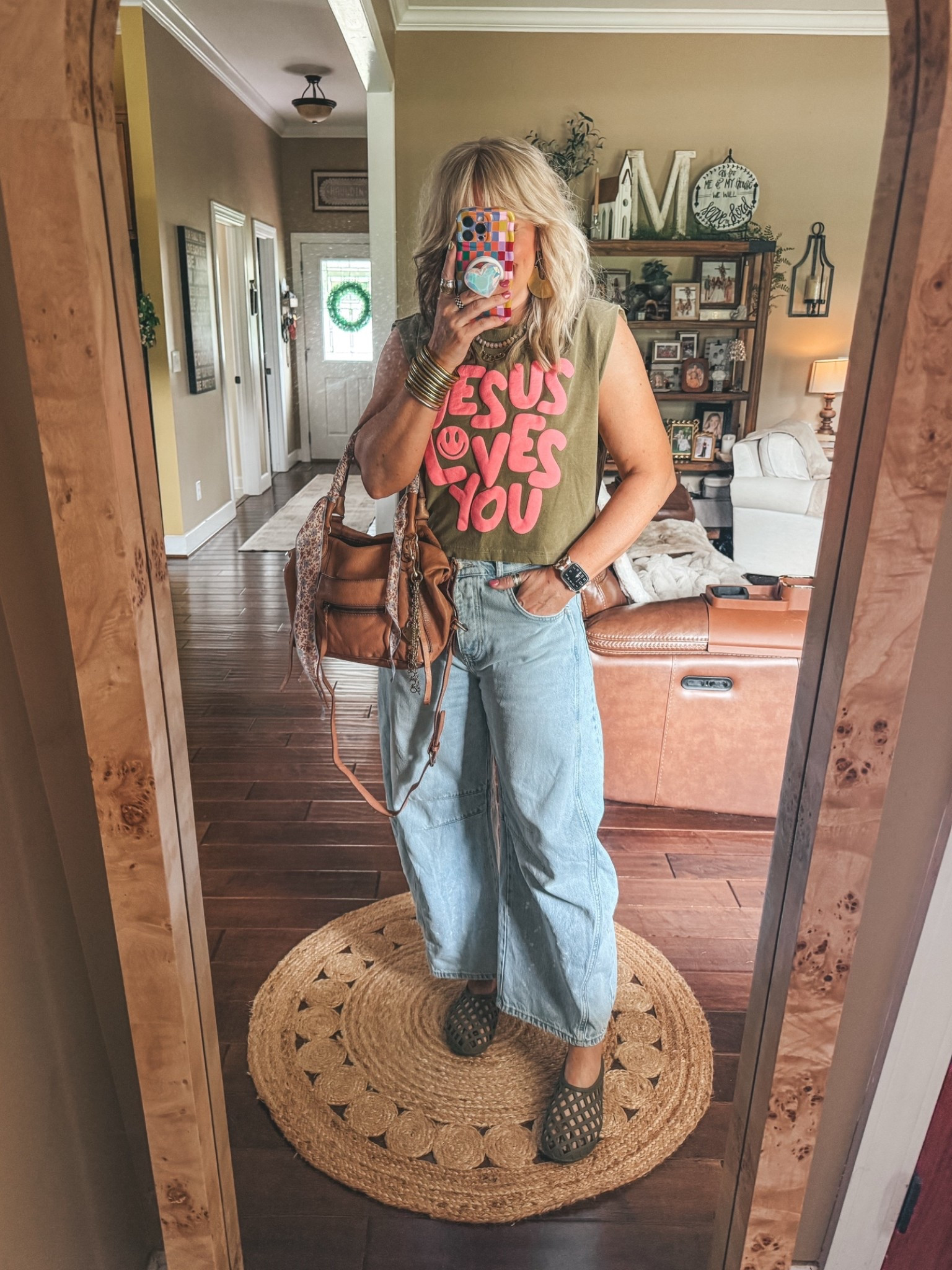 I love this muscle tank. It’s so adorable and I’m linking a lot of fun graphics. I sized down to a small in it so if you want it to be more of a fit like mine I’d size down. 
I also size down in these barrel jeans. 
Jelly shoes are true to size. 
✨Watchband save with code MANDIE

#LTKootd #LTKgrwm #LTKOver40