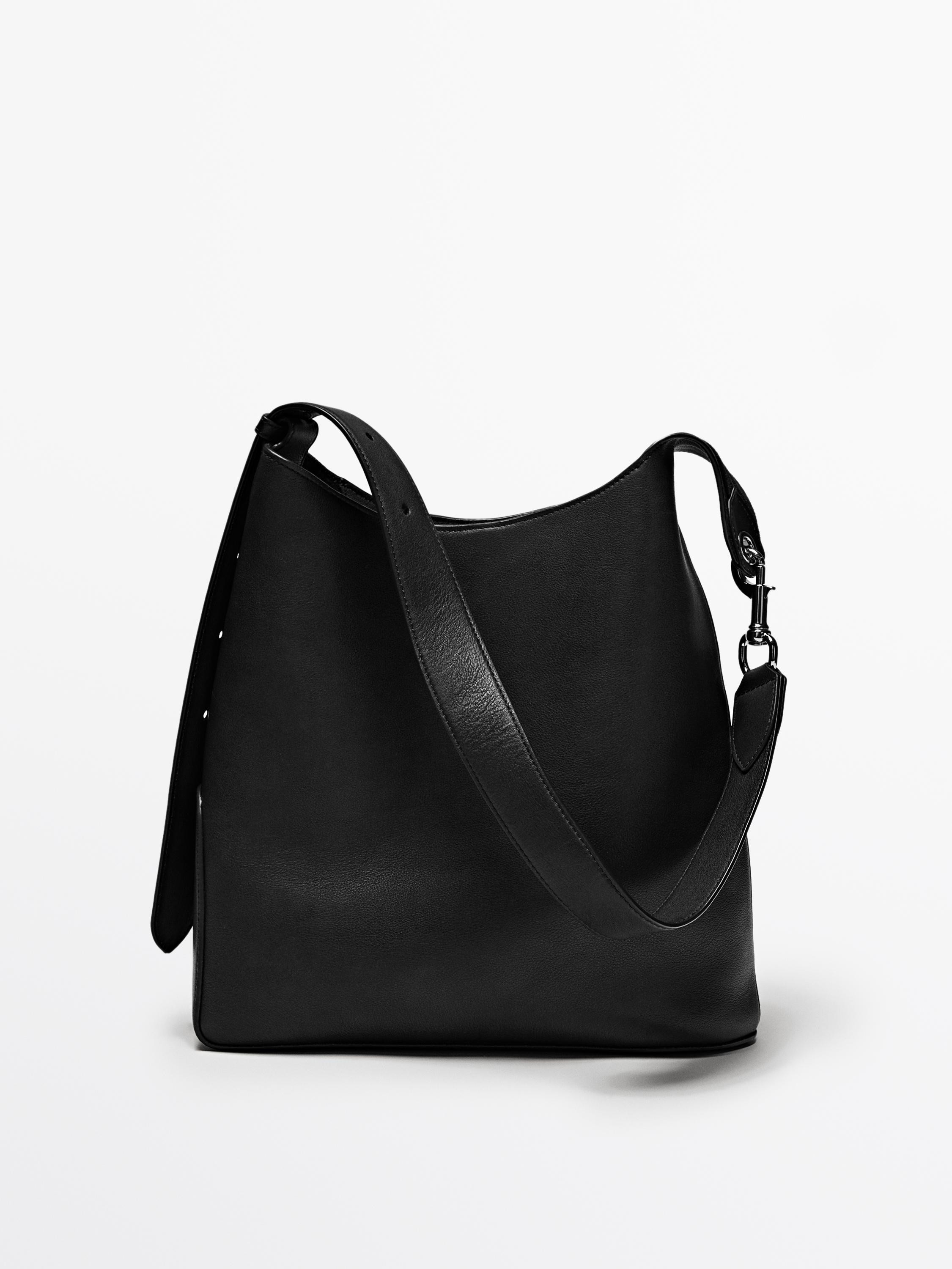 Handbag made of cowhide leather with a nappa finish. Fastens with a leather strap and metallic lo... | Massimo Dutti UK