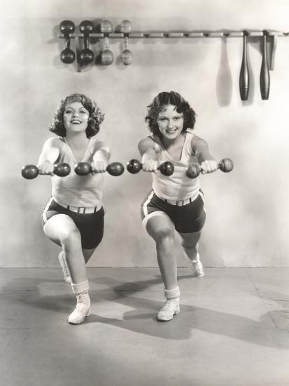 Two Women Exercising with Dumbbells at Gym Photo Print | Art.com