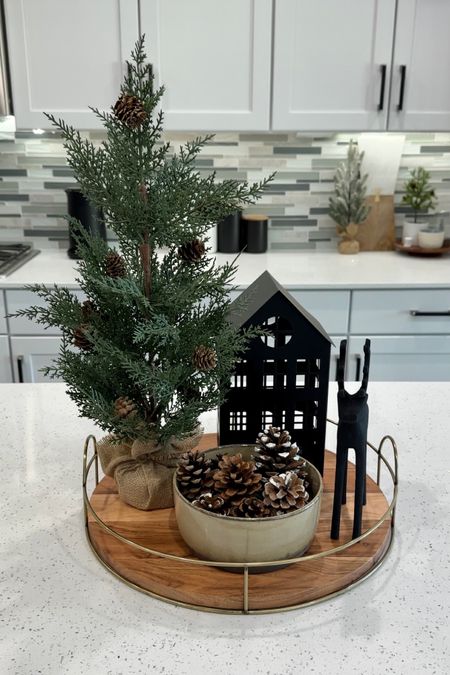Kitchen island holiday styling using a wooden tray, faux greenery with pinecones, black metal house and a black metal reindeer. Christmas decor  

#LTKhome #LTKSeasonal #LTKHoliday