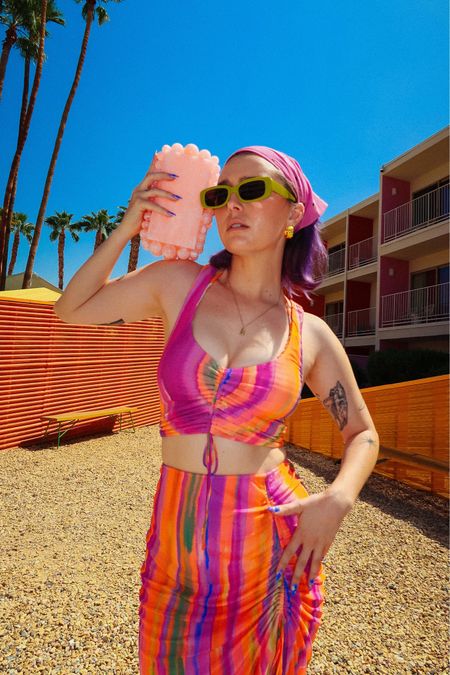 Palm Springs is my love language 🌴

Champagne wears a matching multicolored rainbow skirt and too set with ties, pink pearlescent clutch from cult Gaia and pink jelly slide sandals. 

part pool Palm Springs dopamine dressing maximalist maximalism colorful bright orange Gucci 