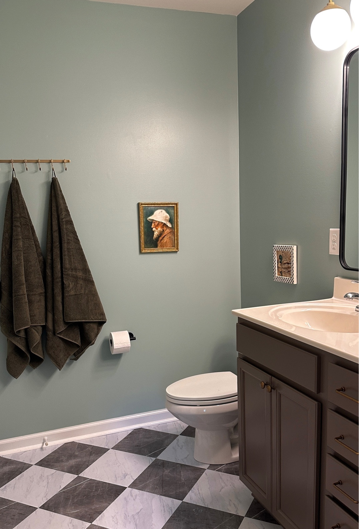 Our primary bathroom feels so grown up now 🥹 the peel and stick tile floor was a game changer!! Wall color is “quietude” by sherwin williams!