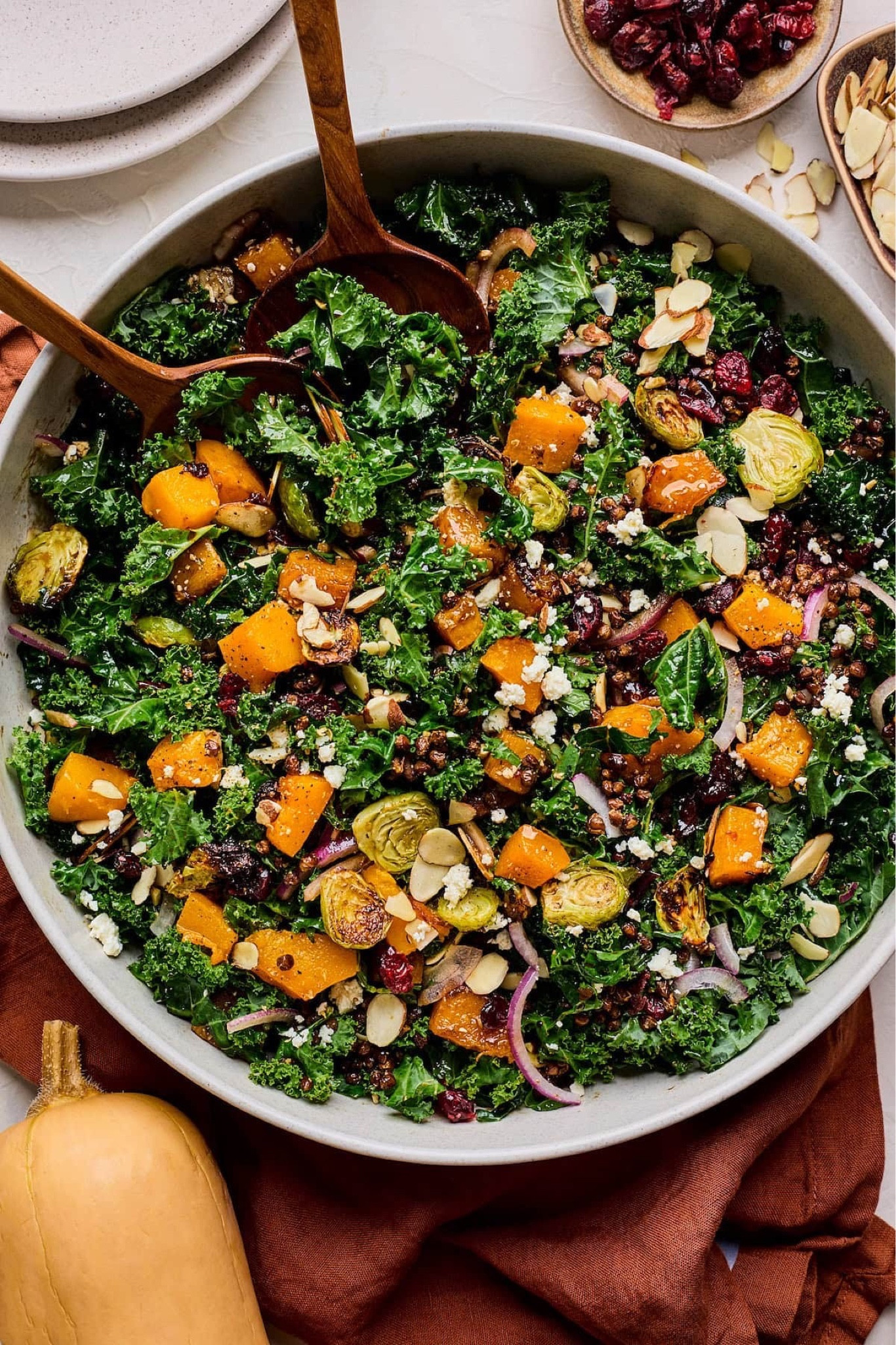 Kale Salad with Roasted Vegetables & Crispy Lentils- hearty kale, roasted butternut squash, Brussels sprouts, crispy lentils, dried cranberries, feta cheese, sliced almonds, and red onion are tossed in a maple balsamic dressing! The perfect salad for fall, winter, and Thanksgiving! Full recipe on my blog at TwoPeasAndTheirPod.com

#LTKHoliday #LTKSeasonal #LTKHome