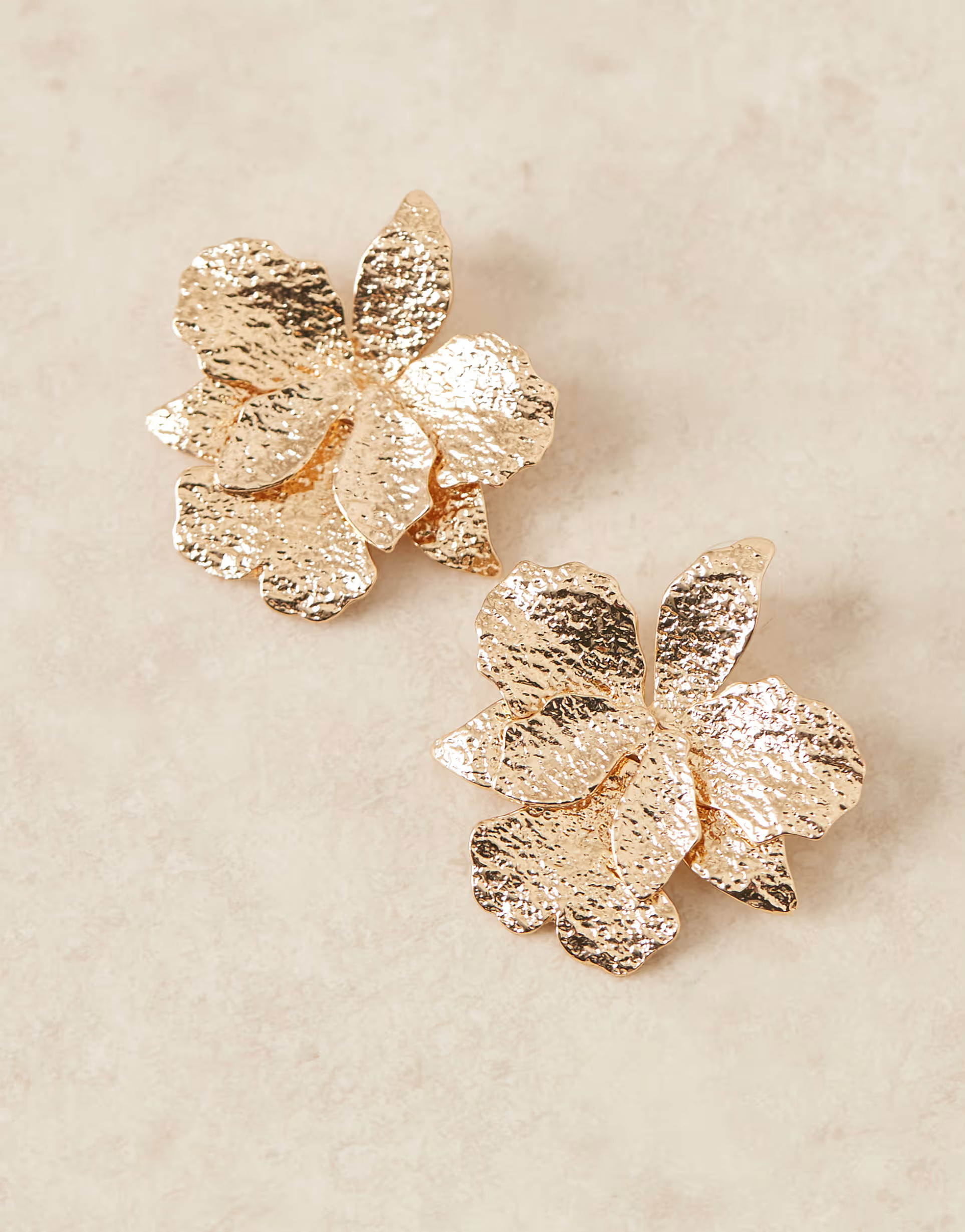 ASOS DESIGN stud earrings with hammered floral detail in gold tone | ASOS | ASOS (Global)
