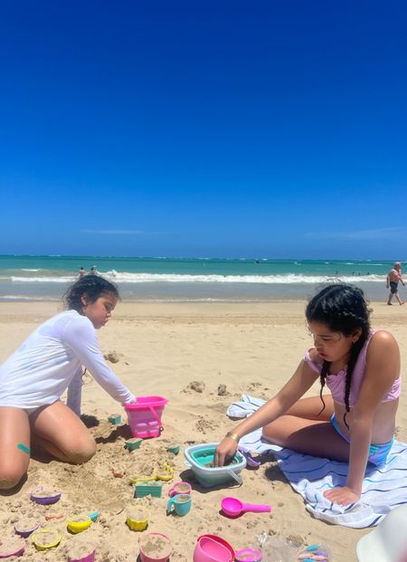 Two travel beach toy sets that the girls are loving. They both bring super useful mesh storage bags and collapsible buckets!