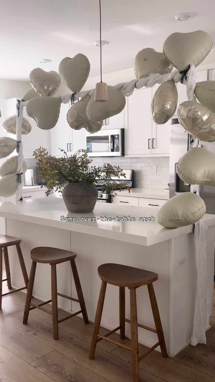 Valentine’s Day doesn’t have to be over the top to feel special! I kept this setup simple, affordable, and functional for our space (considering it’s in our kitchen) using mostly pieces I already have and love (yes, the over-the-table arch again!). It’s one of those decor items I reuse for so many occasions, just styled a little differently each time

Here’s what I used:
— over-the-table arch
— cheesecloth (to cover the arch)
— matte + shiny heart-shaped balloons (the only thing I purchased)
— green accent ribbon (that I already had)

I kept asking my partner, “is this too minimal?” But I realized… minimal is me. Minimal is just my style. I wanted Valentine’s Day to feel special for my little one without the stress, clutter, or extra spending. Sometimes less really is more and this kind of setup lets you enjoy the moment instead of worrying about the setup 💌✨

🏷️ Valentine’s Day set up, Valentine’s Day decor, motherhood, Valentine’s Day gifts, Valentine’s Day for toddlers, SAHM, neutral home decor, simple and minimal decor 

#LTKValentine #LTKHome #LTKKids