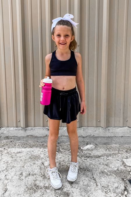 Competitive cheer tryout outfit! Black athletic shorts, black sports bra, big white bow, tumbling shoes! 

#LTKActive #LTKFamily #LTKKids