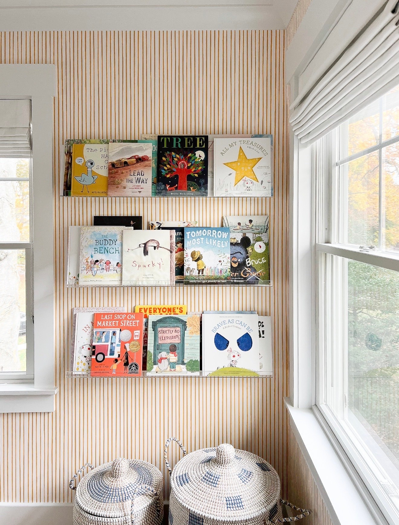 A simple stripe makes such a good backdrop for layering in more color and pattern. I love how the orange wallpaper, colorful book covers and blue woven baskets all work together without feeling too busy.

striped wallpaper, kids room decor, reading nook, woven baskets, pattern mixing, orange wallpaper, blue decor, colorful books, interior styling, Girl on the Hudson

#LTKHome