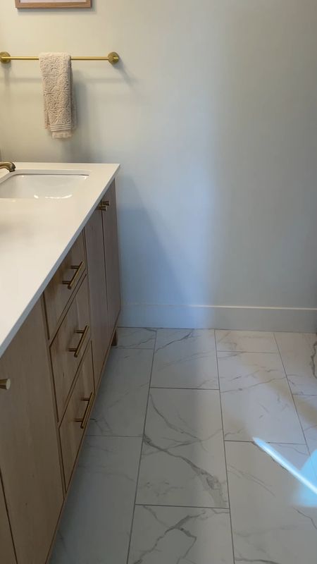 Carrara marble tile is expensive and difficult to maintain.  

In our bathroom, we installed ceramic porcelain 12X24 floor tile that looks like Carrara but is durable, easy to clean and under $2 per square foot.  

Bathroom floor tile.  Lowe’s tile.  Home Depot floor tile.  

#LTKVideo #LTKStyleTip #LTKHome