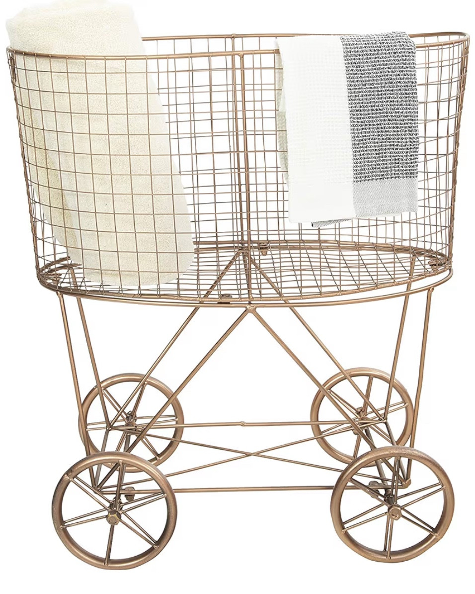 Vintage Reproduction Metal Laundry Basket on Wheels (Copper)

This is absolutely darling and I adore it!
I would use it for reals as the laundry basket… but cute in a bathroom or give as a bridal or wedding gift! Or use in a nursery! Or fill with balls in a boys room! 
