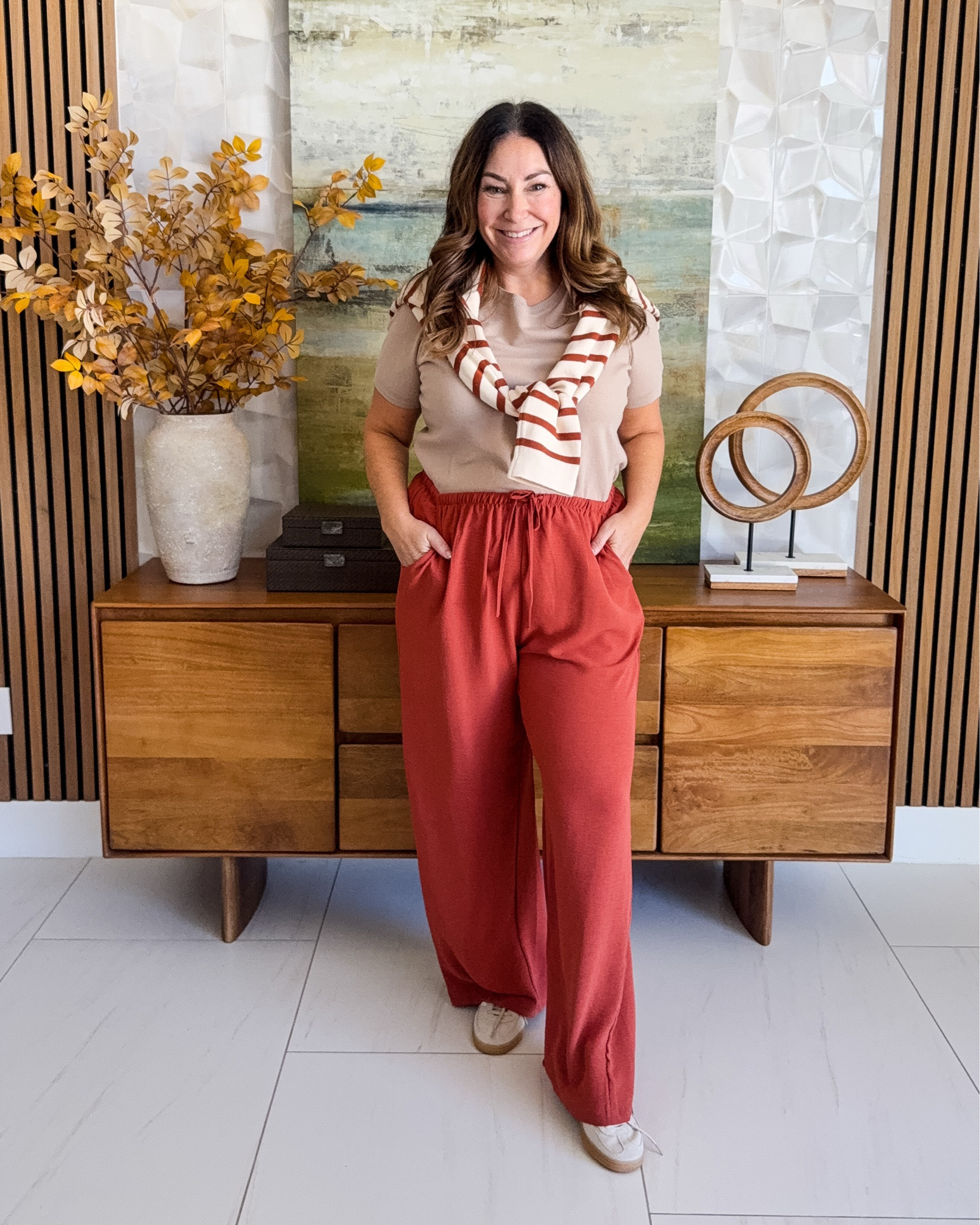 Such a cute way to wear all the warm fall colors without feeling overly “fall.” Love the rust pants with the striped sweater tossed over the shoulders! | Wearing pants run small wearing XL | Top tts, L | Striped sweater, L

#LTKSeasonal #LTKOver40 #LTKMidsize