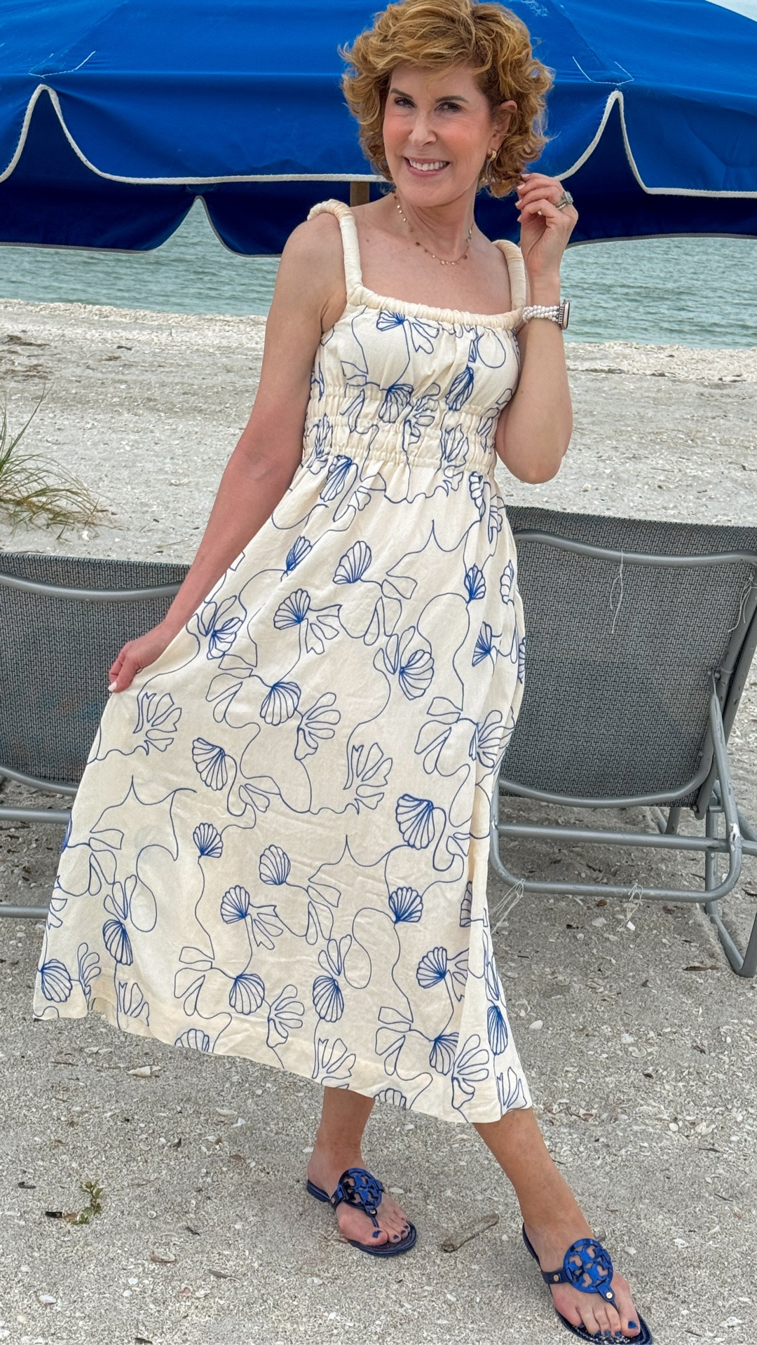 This beautiful maxi dress combines coastal charm with an effortlessly polished silhouette. Featuring a square neckline, thick ruched straps, a flattering smocked waist, and a breezy maxi length, it's as comfortable as it is pretty. The cream background is adorned with stunning blue shell appliqués, making it the perfect choice for beach vacations, coastal getaways, and sunny summer days.

#LTKdayinmylife #LTKOver40 #LTKTravel