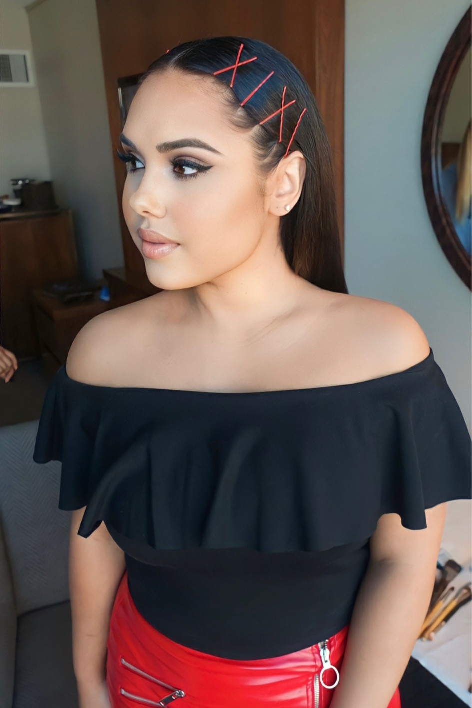 All dressed and ready for a press day 📸🎥 in my Ruffle black off the shoulder body suit and faux red leather skirt. Accessories: Red Bobby Pins & Silver Stud Earrings 

Makeup is a soft glam look with a smokey eye and natural peach lip. 

#LTKHoliday #LTKCyberWeek #LTKGiftGuide