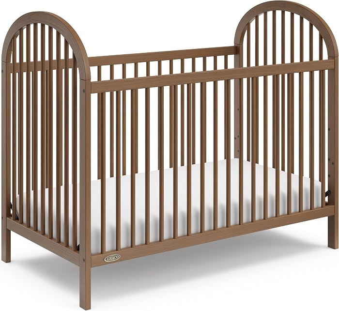 Graco Olivia 3-in-1 Convertible Crib – GREENGUARD Gold Certified, 100% Solid Wood, Fits Standard Baby Crib Mattress, Converts to Toddler Bed and Daybed, 4 Adjustable Mattress Heights (Hazelnut) | Amazon (US)