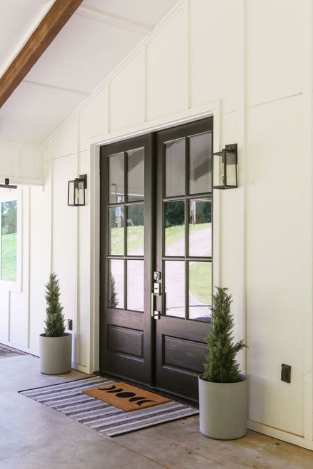Today on the blog I am revealing my DIY painted front doors (Tricorn Black by Sherwin Williams). If you are looking to boost your home’s curb appeal, I highly suggest tackling this beginner-friendly project while the weather is nice! #modernfarmhouse #whitehouse #farmhouse #porch #frontdoor #frontentry #frontporch #porchdecor #entryway #decor 

#LTKSeasonal #LTKHome #LTKFindsUnder50