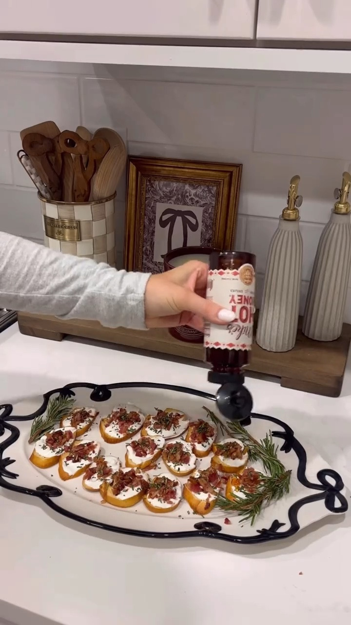 Holiday appetizer idea 🫶🏼 Goat cheese crostini with hot honey and bacon 🤍 this was super simple & tastes delicious! 🥓🍯
Ingredients:
1 baguette
1 pack of bacon
2-3 tbsp fresh chopped rosemary
hot honey (to drizzle)
whipped goat cheese ingredients:
8 oz softened goat cheese (I used 4 oz truffle and 4 oz regular)
2 oz cream cheese (softened)
2 tbsp sour cream 
1 tbsp honey 
Preheat oven to 400. Cook bacon 15-20 mins in oven until crispy. Remove and set aside on paper towel. Combine ingredients for cheese while bacon is in oven in a blender. Once blended, slice baguette and drizzle with olive oil on baking sheet. Bake for around 3-5 min, until golden brown. 
Assemble bread with whipped goat cheese, bacon bits, and fresh chopped rosemary. Top each one with a drizzle of hot honey! Enjoy 🫶🏼

#LTKHome #LTKfoodie #LTKHoliday