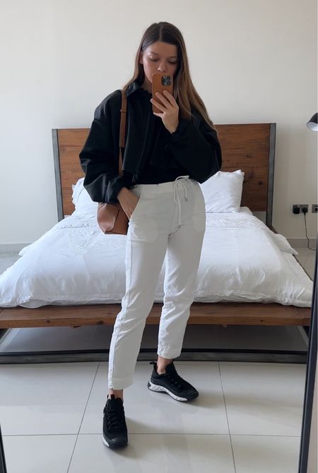 Fall outfit minimal , white trousers, black bomber jacket , loewe puzzle bag, chanel sneakers 