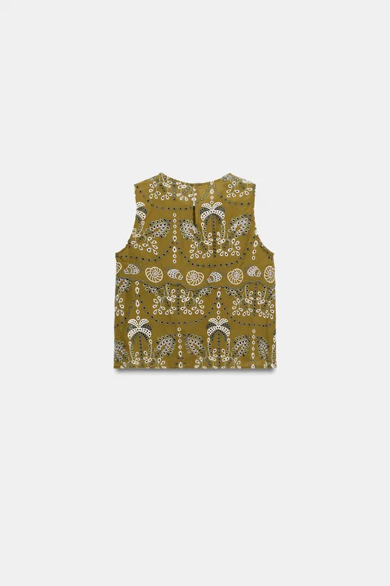Round neck, sleeveless top. Eyelet embroidery detail. Back opening with hidden button closure. | Zara US