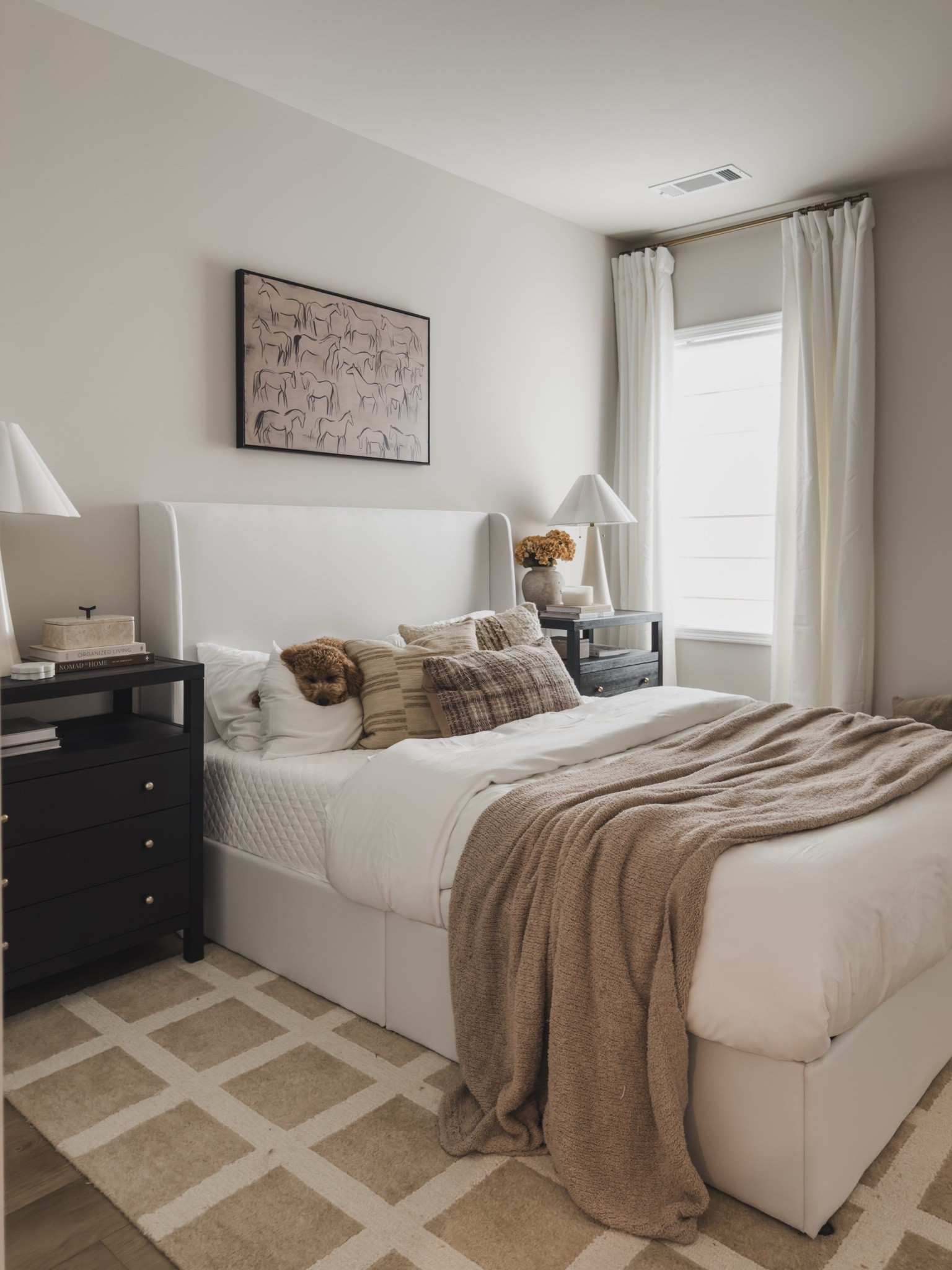 #AD Guest bedroom details I still love from @wayfair

This room is proof that you don’t have to sacrifice style to make a space functional.

The storage bed is one of my favorite pieces in the room. It lifts up to reveal a huge amount of hidden storage, which is perfect for extra bedding, pillows, and seasonal decor.

I also love these nightstands. They each feature three spacious drawers plus a decorative shelf, so they offer plenty of practical storage while still looking elevated.

A few other Wayfair favorites in this space: The scalloped table lamps, neutral patterned rug, modern artwork above the bed, Italian faux linen curtains and all of my favorite throw pillows! 

Everything works together to create a guest bedroom that feels cozy, collected, and functional. #AD #wayfair #wayfairpartner @wayfair