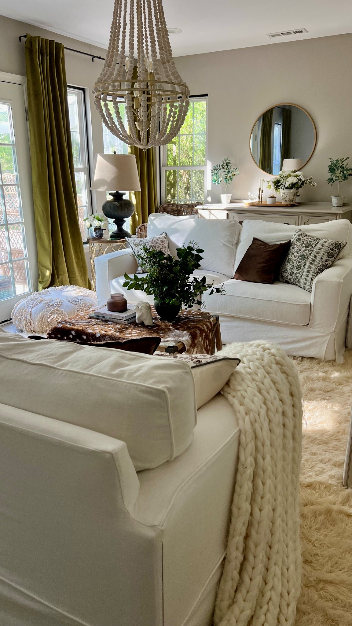 One of my favorite corners right now is my neutral living room! It is comfy, cozy, and full of texture! From the slipcovered sofas, faux deer hide on the coffee table, velvet drapes, block print floral pillows, and fluffy flokati rug underfoot, this space is all about cozy layers. 
#LTKhome #LTKlivingroom #LTKhomefinds #LTKdecor #neutraldecor #slipcoveredsofa #velvetcurtains #beadedchandelier #coffeetablestyling #chunkyknitblanket #warmminimalism #cozyvibesonly #collectedhome #amazonhome #affordabledecor

#LTKHome