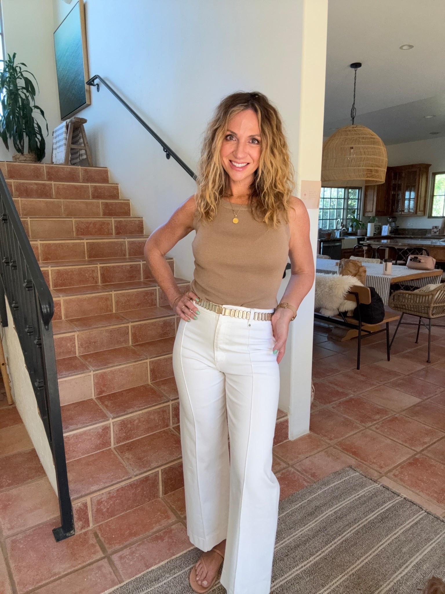 Quiet luxury on a budget 🤍
This is one of my favorite elevated basics outfits for spring and summer-clean, neutral, and so effortlessly chic.

This tank top is the star… it has that soft, cashmere-like feel with a subtle sheen that makes it look way more expensive than it is. I’m wearing the camel in a size small (5’7, size 6) and it has the best stretch + length (perfect tucked or worn long).

Styled here with white denim-style trouser jeans (mine are sold out so I linked similar), a gold stretchy leather belt from Anthropologie, and minimal neutral sandals for that minimalist outfit / quiet luxury vibe ✨

Also linked a fun leopard belt option if you want to switch it up 🐆

✔️ perfect spring outfit + summer outfit staple
✔️ ideal for building a capsule wardrobe
✔️ easy to dress up or down
✔️ comes in multiple colors
✔️ under $25 (!!)


#LTKWorkwear #LTKootd #LTKOver40