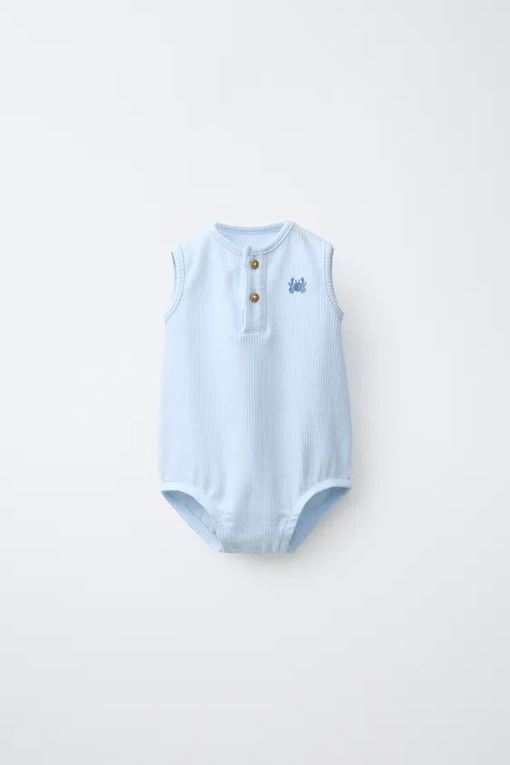 Round neck bodysuit with sleeveless design. Button fastening on the chest and snap buttons at the... | Zara UK