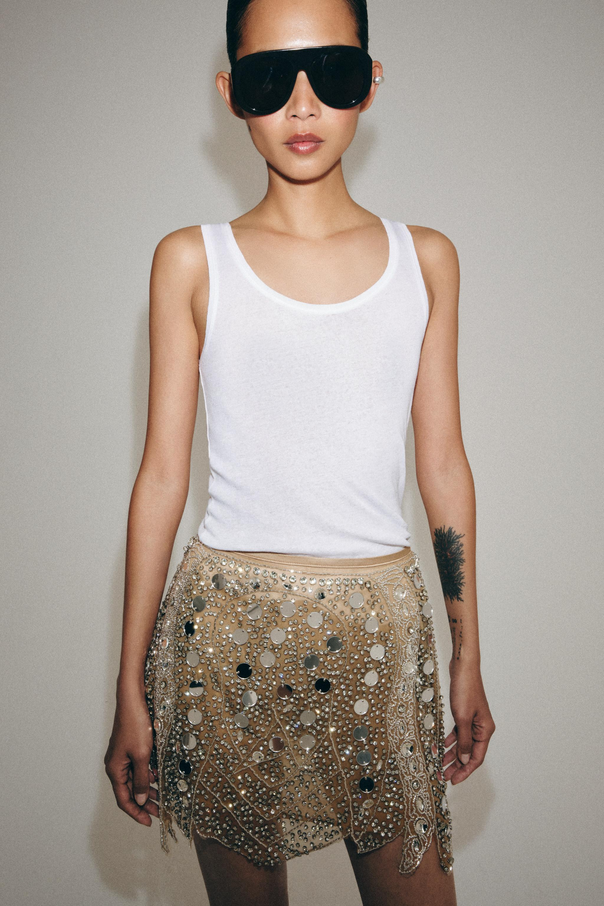 Short skirt with beads. Asymmetric hem. Interior lining. Invisible side zip fastening. | Zara UK