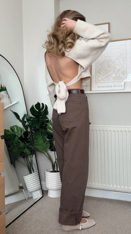 Brown wide leg jeans, open back cream cropped knit jumper, cream mesh ballet flats, cream top handle bag, Jo malone peony and blush suede, Gisou lip oil watermelon sugar 

#LTKVideo #LTKstyletip #LTKSeasonal