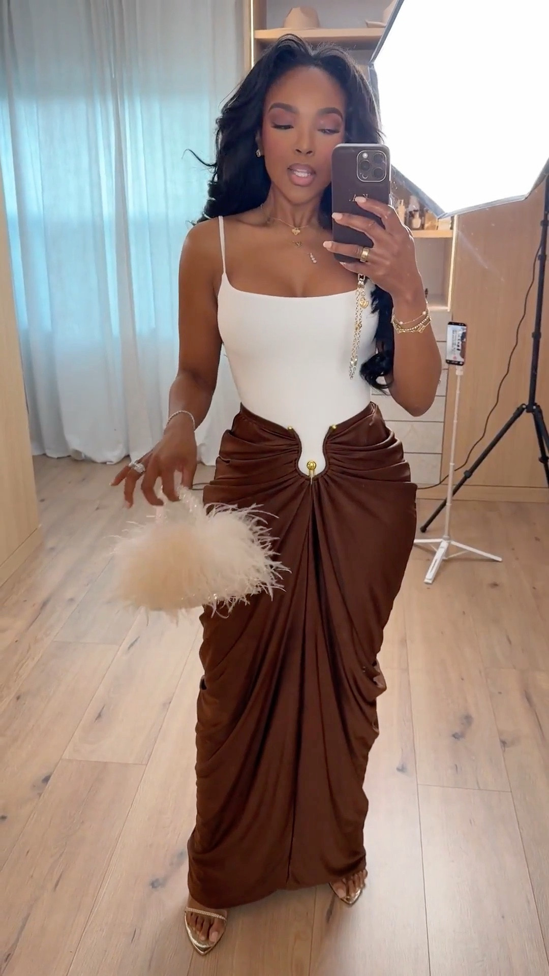 This look is all about elevated neutrals 🤎 A crisp white bodysuit paired with a draped brown skirt instantly feels luxe and timeless. Each piece works beautifully on its own, but together it’s that effortless, styled-to-perfection moment — and the cost per wear drops fast when you mix these staples into your rotation.

Perfect for dinner dates, special occasions, vacations, or dressed-up evenings out.

📏 Sizing:
Bodysuit: Size Small  
Skirt: Size Small  
Heels: True to size  
Height: 5'4" | Weight: 138 lbs | Bust: 34D | Waist: 27" | Hips: 40"

Tap to get details and shop everything linked.

Neutral evening outfit, brown skirt outfit, white bodysuit styling, elevated date night look, capsule wardrobe staples, long-term shopping strategy.

Follow me on Instagram and YouTube @kirasfashionfinds