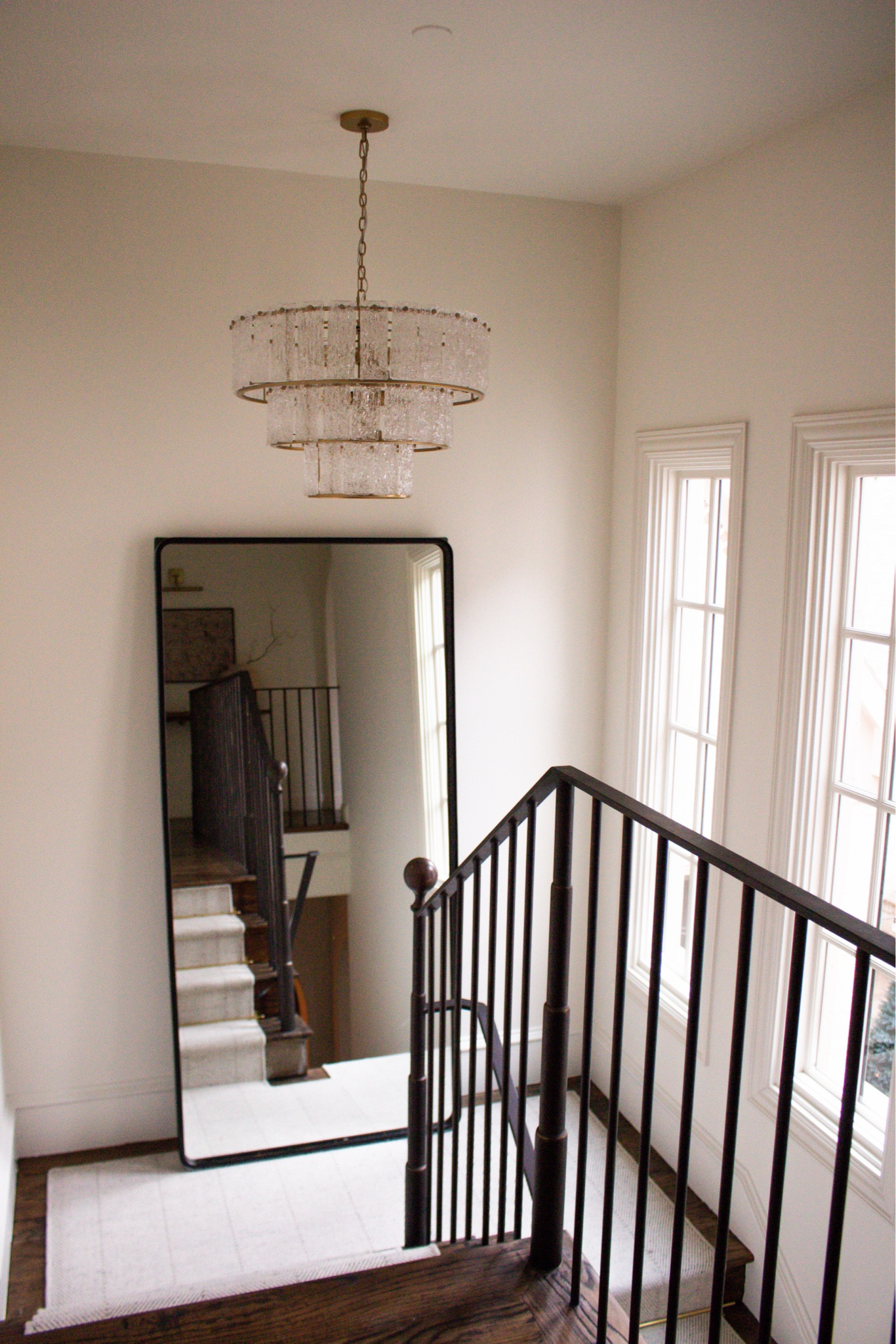 This staircase moment is so simple but so beautiful. The oversized floor mirror, soft neutral walls, and statement chandelier make the whole space feel open, bright, and elevated.

staircase decor ideas, oversized floor mirror, entryway mirror styling, stair landing decor, neutral home design, modern traditional home, staircase inspiration, chandelier lighting, bright airy interiors

#LTKHome #LTKSeasonal
