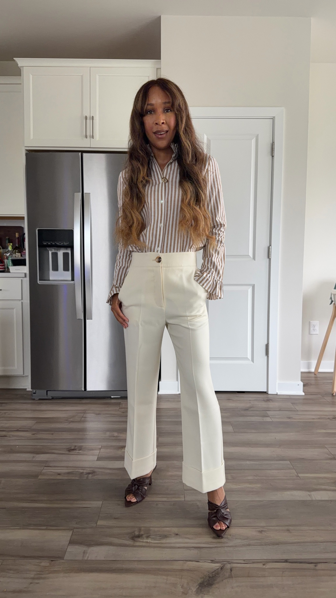 Tan and cream workwear outfit with striped top and pleated pants

#LTKootd #LTKPetite