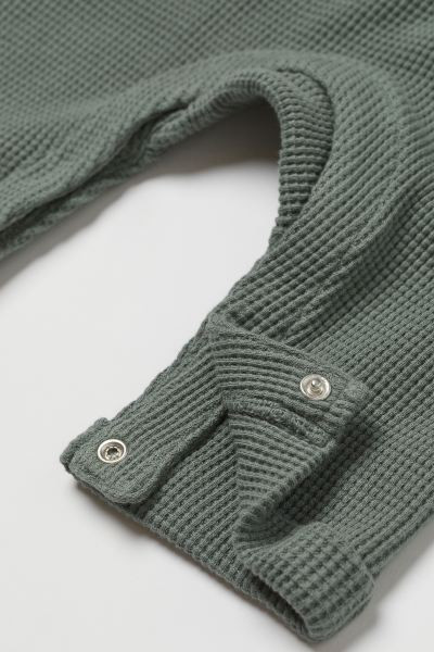 Baby Exclusive. Sleeveless romper suit in soft, organic cotton slub jersey. Button placket, ribbi... | H&M (US + CA)