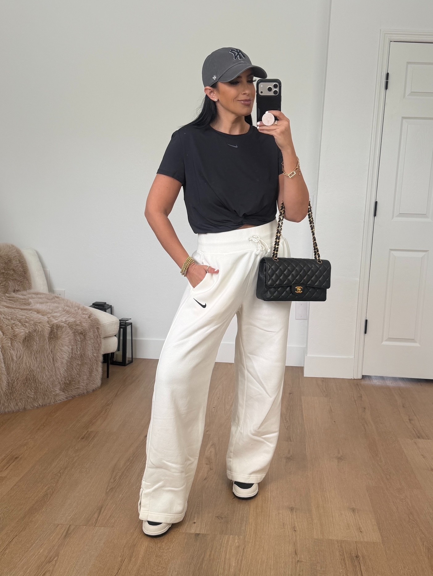 Nike One Classic Twist Women's Dri-FIT Short-Sleeve Top wearing size medium. Sportswear Phoenix High Waist Wide Leg Sweatpants wearing size medium. 