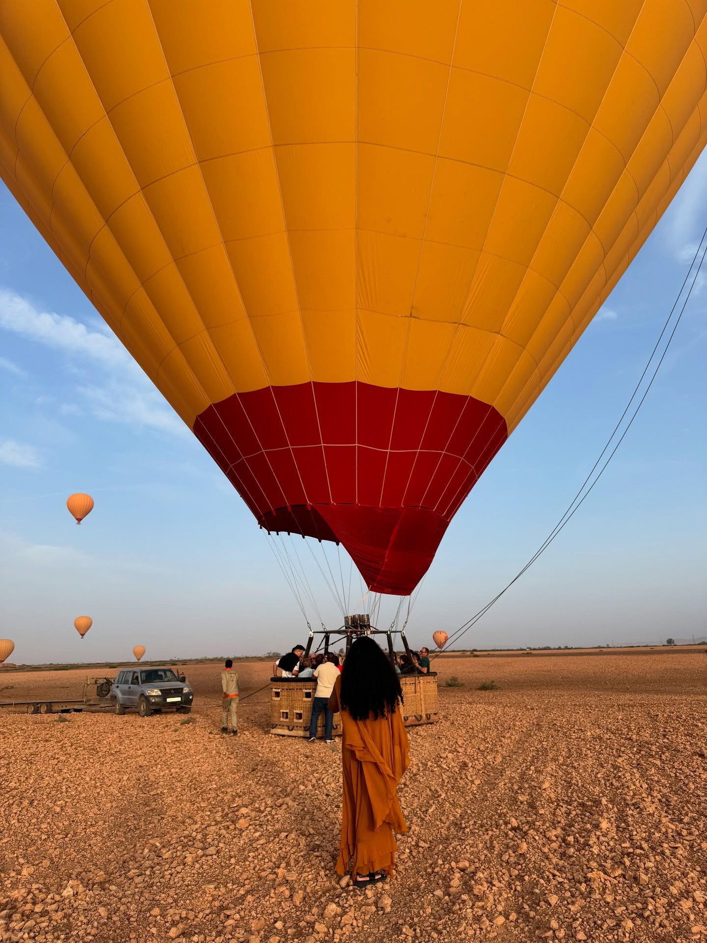 Tfw I’ll never be 6k miles from home, solo in my 20’s riding my first hot air balloon 😭💛

Y’all already know if there’s a way to cut out the middleman when planning my trips, I’m gonna do it. I linked the EXACT booking I did in my Linktree, so if anyone is planning their own trip to Morocco, you now have a recommendation. 

For the hot air balloons, we booked it ourselves through @getyourguide. I think we started at 7 AM with pickup from Marrakesh (nearest to our hotel), and the experience included snacks beforehand, the hot air balloon ride, round-trip transportation, a traditional Berber breakfast, and camel rides! We decided to go with this one because it had the extra activities and breakfast, unlike other trips. 

DO pack some treats for yourself, this will take about 4 hours total. DO wear sunscreen. DO leave your bags at home unless you’re carrying a camera (like me). DO use the bathroom before the camel rides. DO not wear flip flops. DO not wear short skirts.