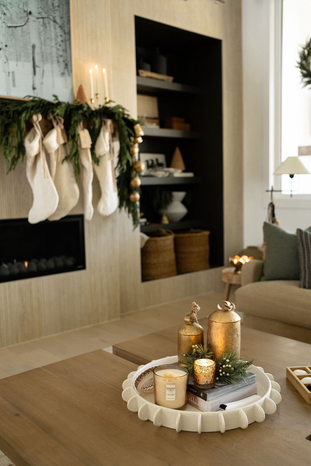 The coziest Christmas glow 🤍🎄✨ Loving the mix of neutral knit stockings, faux Amazon cedar garland, amazon affordable gold bells, and this warm coffee table holiday vignette with candles + winter faux greenery. Perfect inspo for neutral Christmas decorating, modern classic holiday decor, living room Christmas ideas, LTK holiday home finds, and cozy winter home styling. 🫶🏻

#LTKHome #LTKSeasonal #LTKHoliday