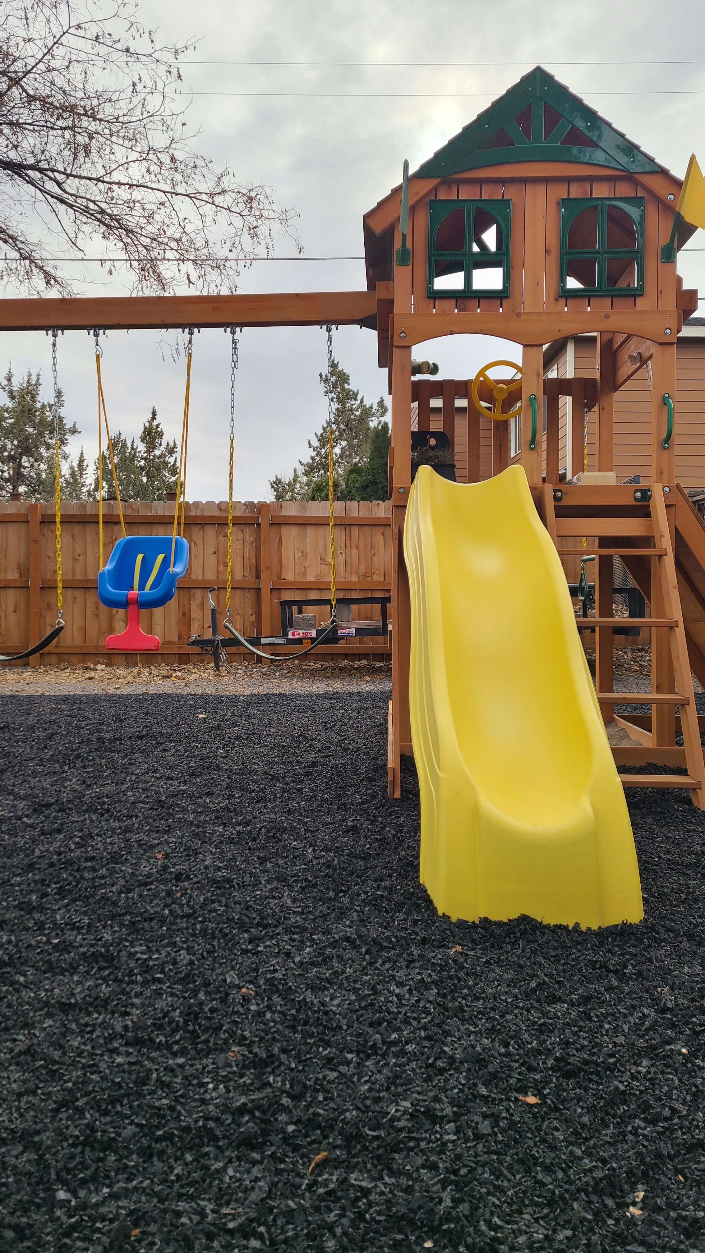 A wooden playset with swings, a rock wall, a treehouse, a slide, and a sand pit. This is the kind of backyard setup that keeps kids outside all day. No screens, just fresh air and imagination.  

 #LTKHome #LTKKids