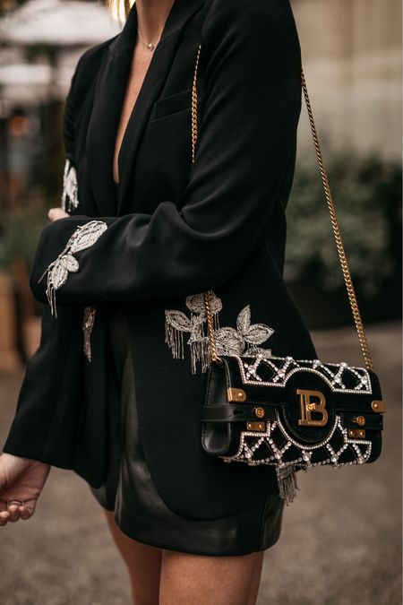 Similar embellished blazers, Balmain purse, faux leather shorts and black bodysuit.

#LTKstyletip #LTKtravel #LTKSeasonal