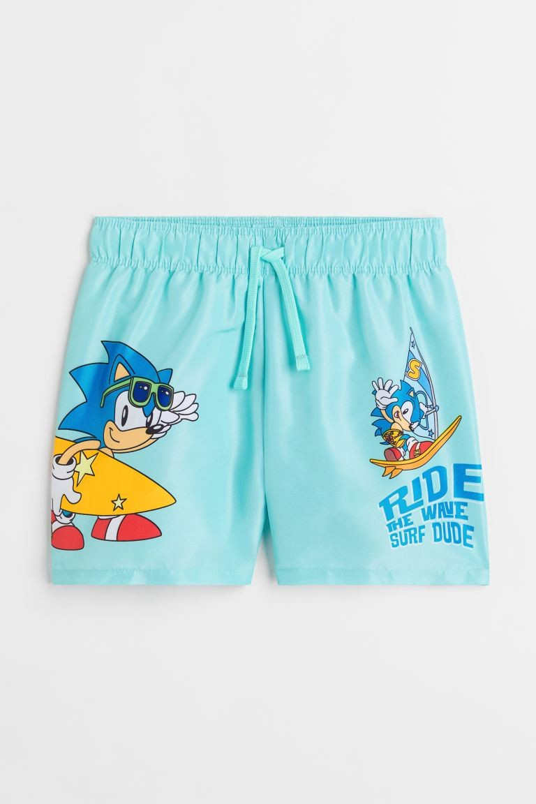 Conscious choice  Swim shorts with a printed motif. Drawstring and covered elastic at waistband. ... | H&M (US + CA)