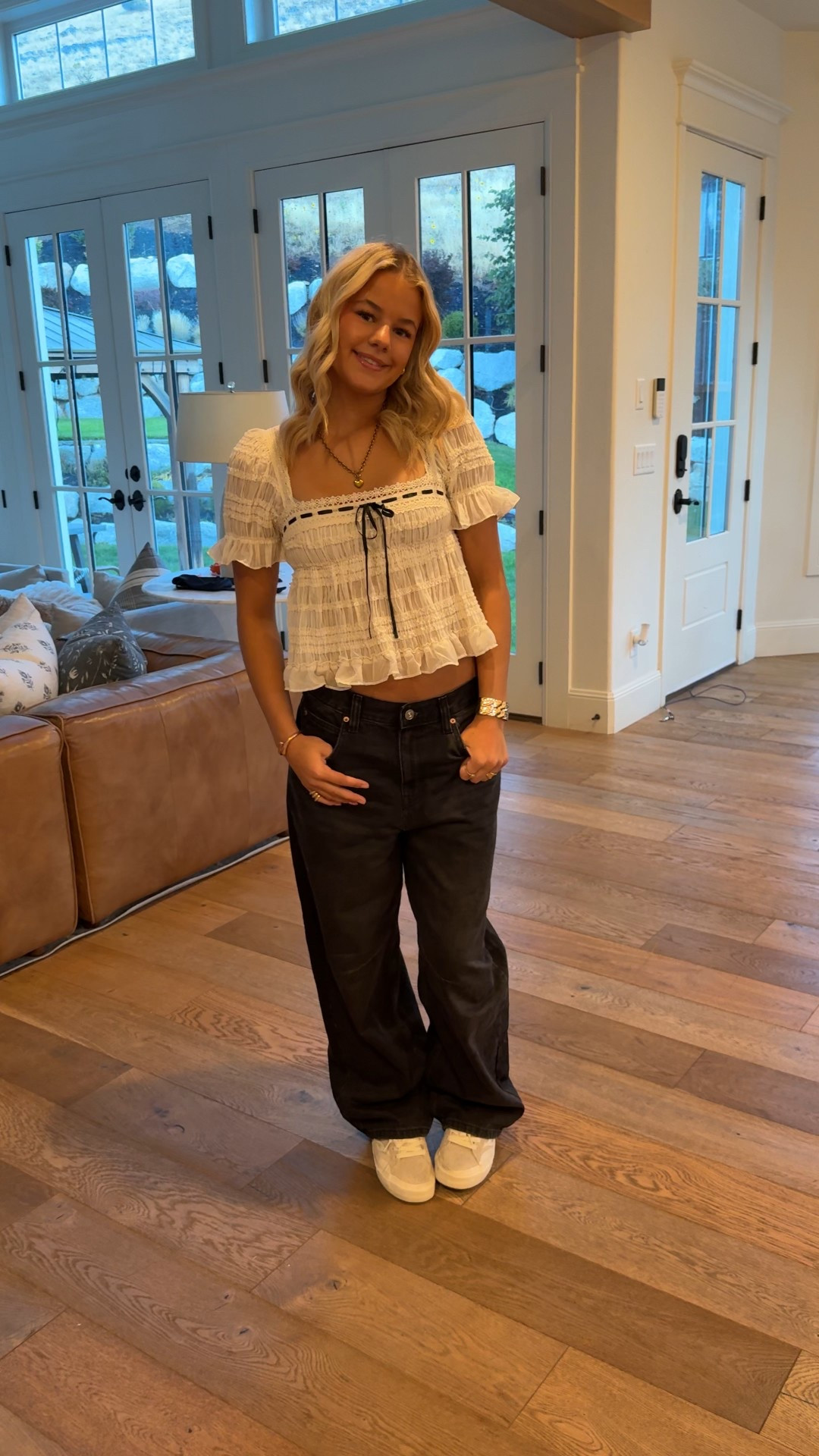 babydoll blouse designed in a shirred, ruffle-trimmed chiffon. Babydoll top featuring a lace-trimmed square neckline, short puff sleeves and a tie-back detail. All topped with ruffled trims and a woven ribbon & bow detail for a femme finish. 

Black Jeans 
baggy silhouette are best-sellers for a reason! Loose jeans designed in a rigid cotton denim that will soften with wear featuring a slouchy waistline with an adjustable buckle at the back for an adjustable rise, 5-pocket styling and light distressing at the hem for an effortlessly lived-in look.